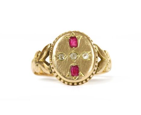 A Victorian 15ct gold ruby and diamond ring, the oval head with a rose cut diamond grain set to an off set square collet at t