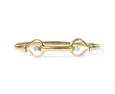 A 9ct gold diamond bangle, the top half with a central bar with a brilliant cut diamond rub set to a plain collet at each end