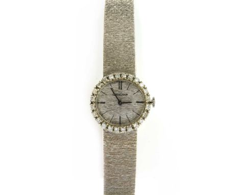 A ladies' white gold diamond set Jaeger-LeCoultre mechanical bracelet watch, with an oval landscape case, 25 x 22mm, to textu