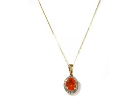 A gold fire opal and diamond cluster pendant, with an oval mixed cut fire opal, approximately 8 x 6mm, claw set to surround o