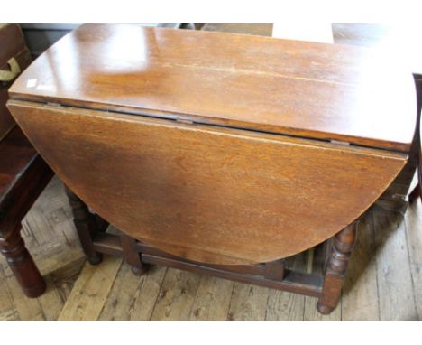 A drop leaf oval oak gate leg table