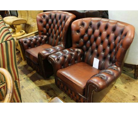 Pair of red leather deep button back wing easy chairs
