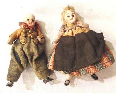 Miniature ceramic dolls, man and woman, with jointed arms and legs, appear in original clothing, approximate H: 9 cm. P&amp;P