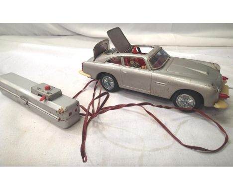 James Bond Aston Martin DB5 with non fall action, tinplate, battery operated, remote control, made in Japan. Fair condition, 