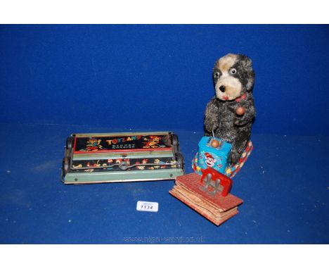 A Toyland Carpet Sweeper (no handle), a small toy Squeeze Box (Barcelona) and a musical Dog playing a drum, (ear missing.)