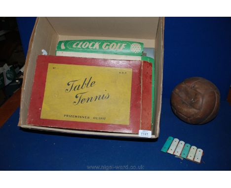An old leather Football, clock golf Game and an old table tennis set.