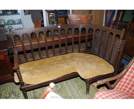 An unusual 19th c. Oak Corner Bench Seat, having curved top rail on bobbin turned supports and rectangular slats, cane seat w