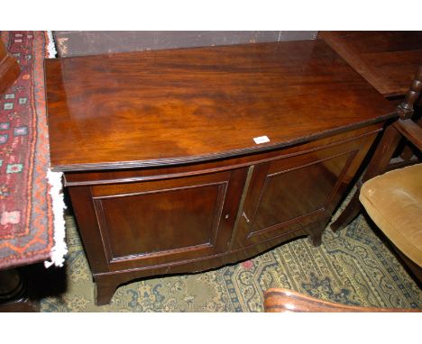 A 19th c. Mahogany bow fronted, two door Cabinet, having plain top with reeded edges over the pair of opposing single moulded