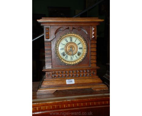 A late 19th c. Oak cased architectural Mantle Clock having moulded layered top over corbelled and stepped columns flanking th