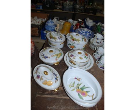 Five Royal Worcester 'Evesham' lidded casserole Dishes, two pie dishes and two large oval serving dishes.