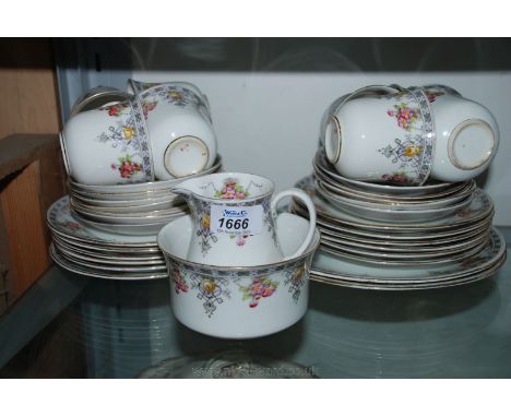 A Victoria china Teaset decorated with small flowers including twelve side plates, eleven saucers, eight cups, two bread and 