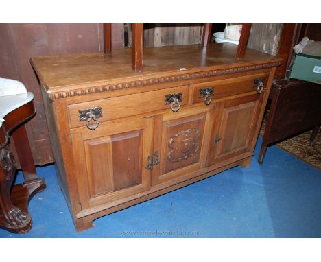 A good Art Nouveau light Oak Sideboard, having moulded edge rectangular top over applied moulded frieze, two Oak lined, mould