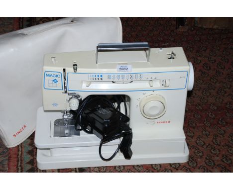 A Singer electric Sewing Machine Magic 34, with plastic case.