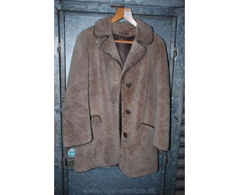 A three quarter ladies Sheepskin jacket by Owen Barry, light fawn with brown leather collar and piping.