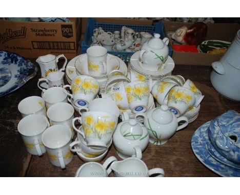 A quantity of Daffodil design china including 16 plates, 15 cups and saucers, six jugs, sugar bowls and mugs,five soup bowls 