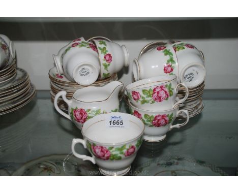 A Royal Vale Teaset comprising eleven cups, fourteen saucers, twelve side plates and a milk jug, white with red roses decorat