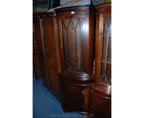 A reproduction Georgian style floor standing Corner Cupboard having moulded cornice over castellated detail and having upper 