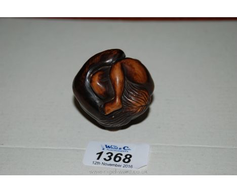 A Japanese wooden erotic Carving of a two figures entwined to make the shape of a ball and to be used as a walking stick knop