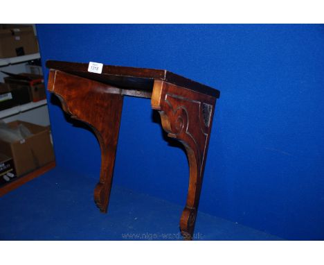 A Victorian Mahogany Wall Shelf, having rectangular top secured with brass screws to two shaped and carved corbel style brack