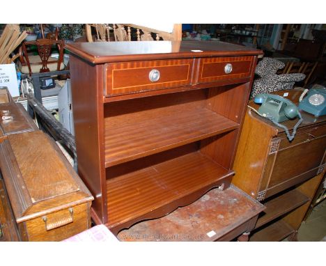 A Mahogany finished Regency style Cabinet Bookcase, the moulded edge top over two frieze drawers with brass ring handles, ove