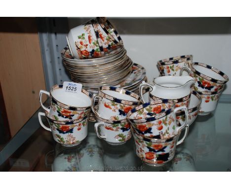 A pretty Teaset in floral, amber and blue decoration, twelve each cups and saucers, nine tea plates, two bread and butter pla