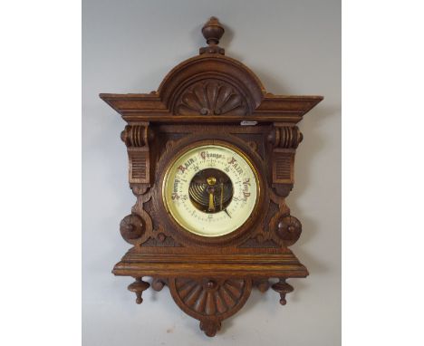 A Late Victorian Aneroid Barometer in Carved Oak Frame. 
