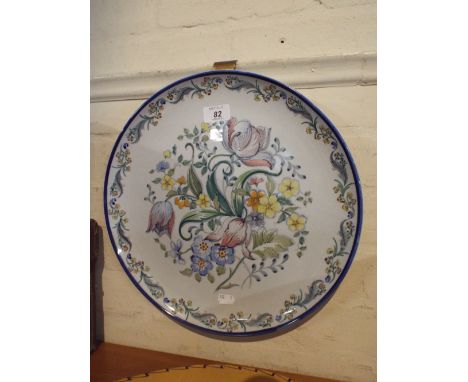 A Circular Floral Ceramic Wall Plaque.