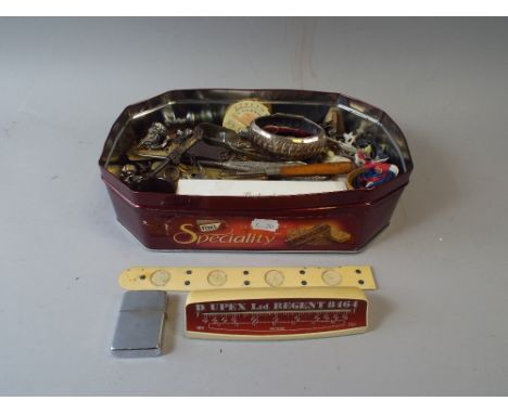 A Tin of Curios to Include Button Hooks, Buckingham Palace Pen, Miniature Model Guns, Metal Ware, Put and Take Etc.