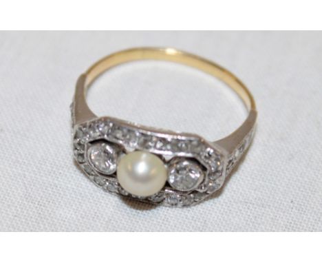 An 18ct gold dress ring set central pearl flanked by numerous diamonds (4g) 