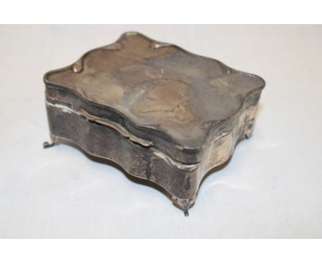 A George V rectangular silver jewellery box with hinged lid on four scroll feet, Birmingham marks 1923