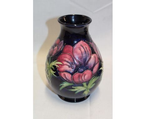 A Moorcroft pottery tapered vase with anemone decoration on blue ground  7" high 