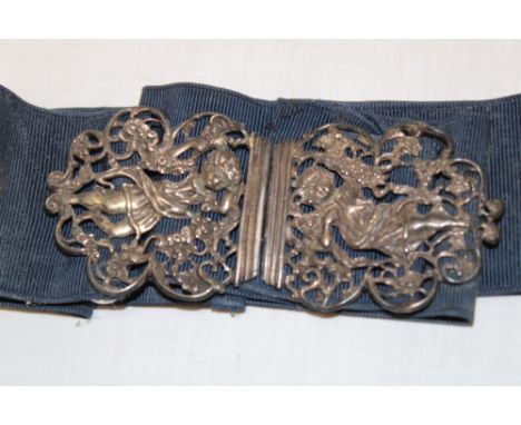 A silver two-part nurse's buckle with raised and pierced cherub and foliage decoration, London marks with satin belt 