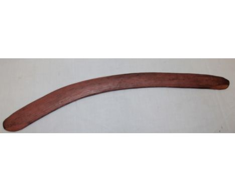 An Aboriginal carved wood boomerang, 29" long 