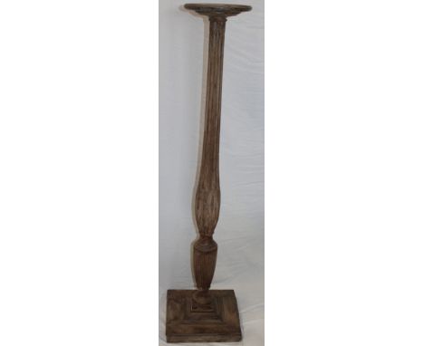 A Victorian stained mahogany torchere with fluted column on square base