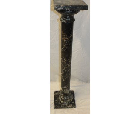 A good quality black veined marble torchere with cylindrical column and square base 39½" high 