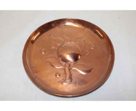 A Newlyn copper circular dish decorated in relief with an apple, stamped "Newlyn" 6" diameter