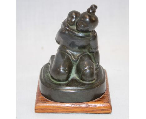 A small Japanese bronze figure of a seated female with child 2½" high 