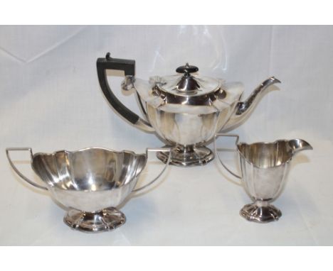 A good quality silver plated oval three piece tea set comprising an oval pedestal coffee pot with ebonised handle, matching t