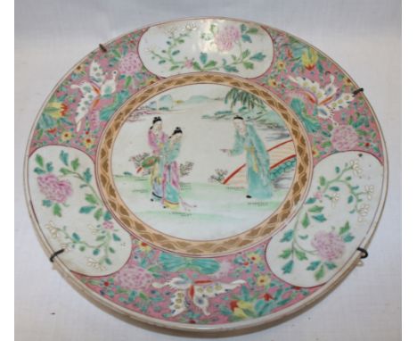 A 19th Century Cantonese pottery circular charger with painted figure decoration within floral borders 12" diameter