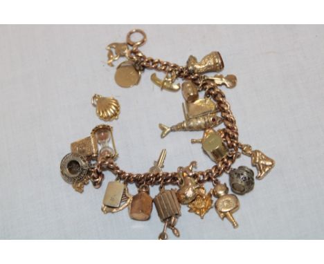 A 9ct gold charm bracelet supporting various 9ct gold and other charms (52.7g gross)