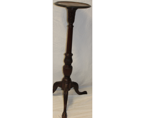 A good quality mahogany circular torchere with circular top and fluted column on tripod base