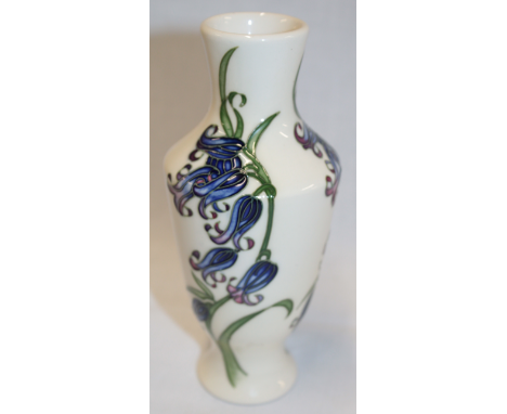 A Moorcroft pottery tapered vase with floral decoration on cream ground dated 2009 6" high