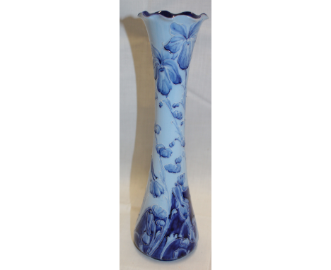 A Moorcroft pottery Florianware tapered vase with floral decoration on blue ground, signed W. Moorcroft 12" high 