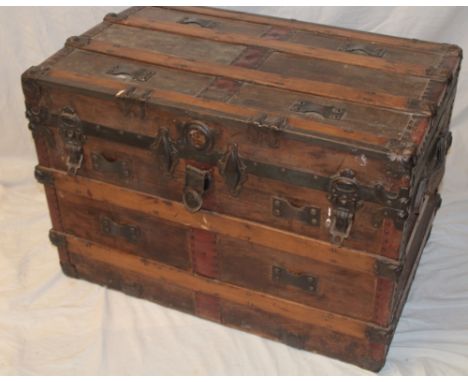 An old rectangular cabin trunk with raised metal mounts 33" long