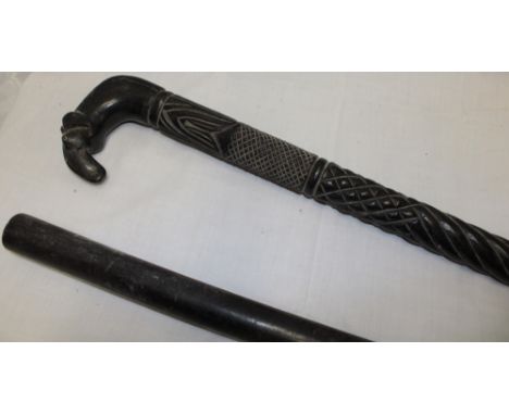 An African carved ebony walking stick with elephants head handle and one other ebony staff (2)