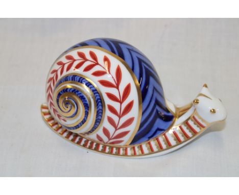 A Royal Crown Derby china paperweight in the form of a snail with silver stopper 