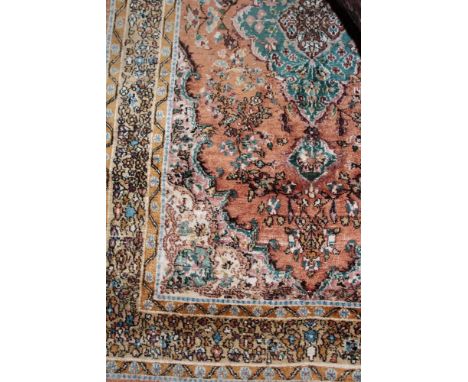 An Eastern embroidered silk  rectangular rug with floral decoration on red, blue and cream ground 57" x 36"