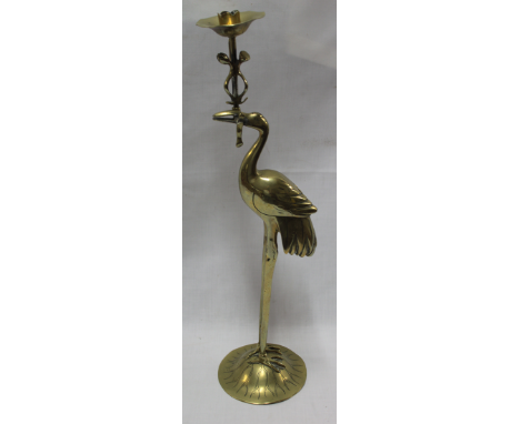 A good quality brass ornamental candlestick in the form of a crane holding a candle sconce 21" high 