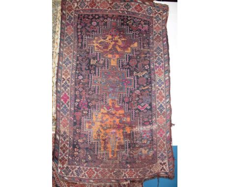 An Eastern hand knotted rug with geometric decoration 70" x 47" (af) 