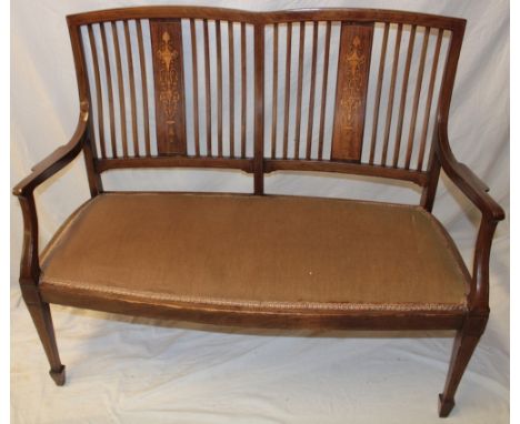 An Edwardian inlaid mahogany two seat parlour settee with rail back and upholstered seat on square taped legs